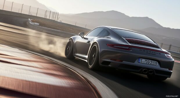 Sports Car Wallpaper with a Porsche 911 Carrera drifting on a sharp curve of a racetrack, with smoke trailing behind the tires.