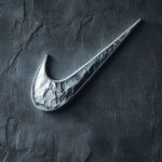 Stylish Nike wallpaper with a large metallic silver swoosh on a textured dark gray background.