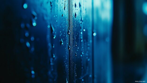 Subtle raindrops falling against a blurred glass effect on a dark blue background.