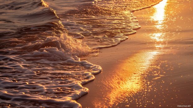 Waves gently lapping the shore during a golden hour ocean sunset.