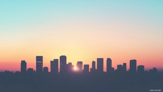 Widescreen 1080p Wallpaper with silhouette of a modern city skyline at sunset, soft gradient sky.