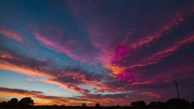 Vibrant summer sky wallpaper with hues of magenta and orange bursting with energy.